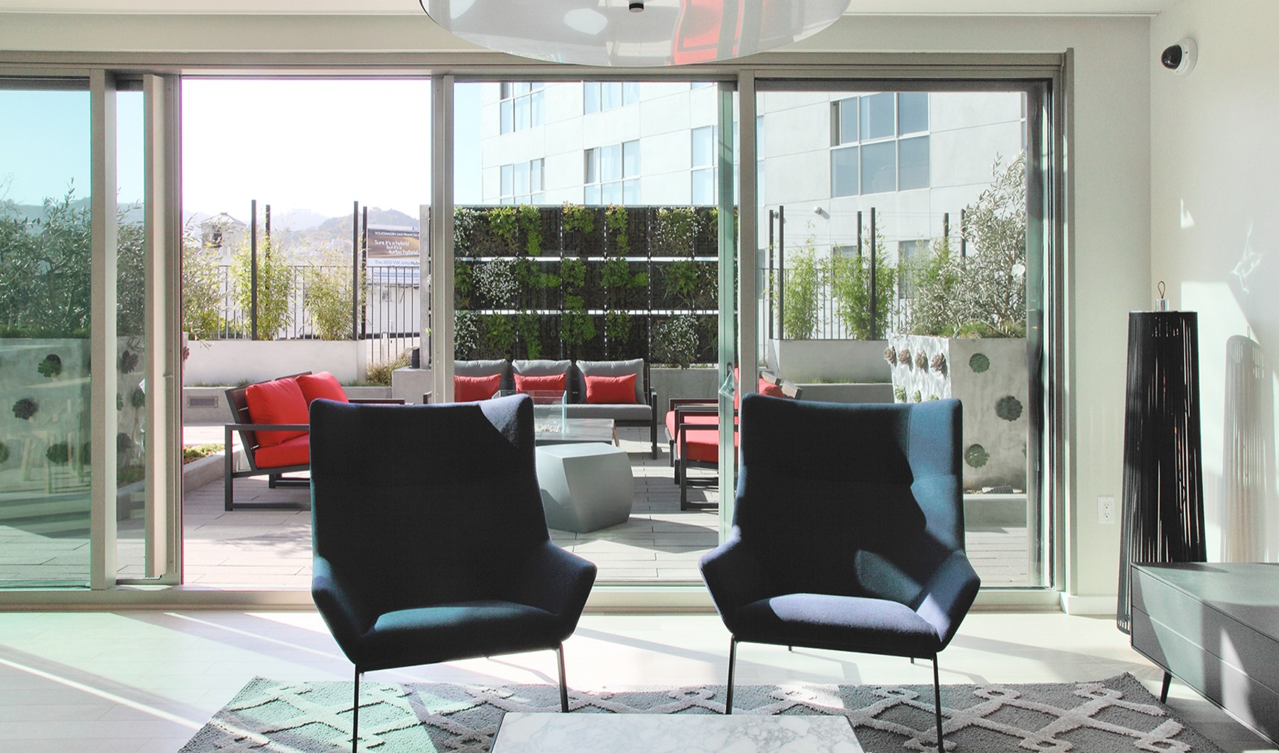 Rotator Image Lounge area with two large black chairs