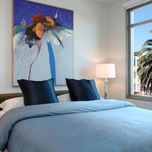 Bedroom bedroom with tropical landscaping views through the large window
